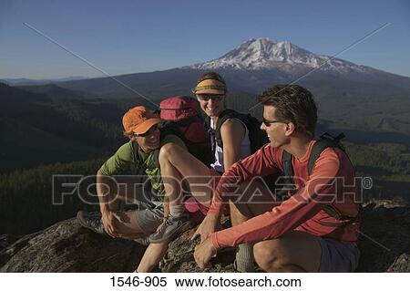 Stock Photography - Three hikers on a mountain summit, Mt Adams, Washington State, USA. Fotosearch
