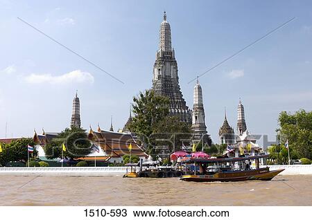 Tourboats in a river with a temple in the background, Wat Arun, Bangkok, Thailand View Large Photo Image Stock Image - Tourboats in a river with a temple in the background, Wat Arun, Bangkok, Thailand. Fotosearch