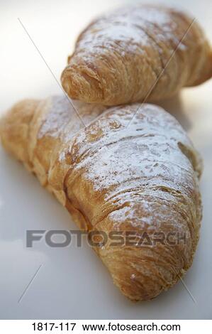 Two baked croissants on a table View Large Photo Image Stock Photo - Two baked croissants on a table. Fotosearch