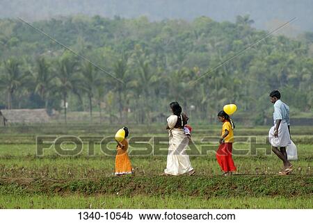 Two girls walking with their parents, Kerala, India View Large Photo Image Stock Image - Two girls walking with their parents, Kerala, India. Fotosearch