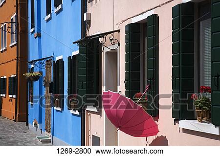 Stock Image - Umbrella hanging on the window of a house, Burano, Venice, Veneto, Italy. Fotosearch