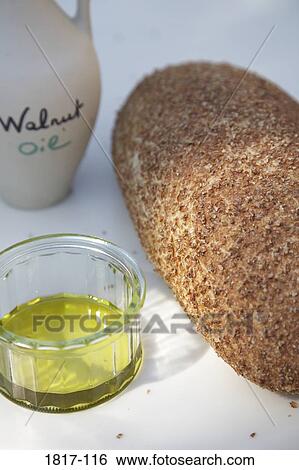 Walnut oil and a bread on a table View Large Photo Image Stock Photograph - Walnut oil and a bread on a table. Fotosearch