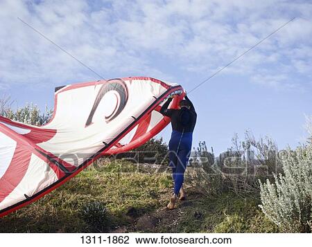 Windsurfer carrying windsurfing board up on a hill, Hampton Beach, Melbourne, Victoria, Australia View Large Photo Image Stock Image - Windsurfer carrying windsurfing board up on a hill, Hampton Beach, Melbourne, Victoria, Australia. Fotosearch