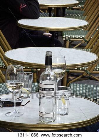 Wine bottle and wine glasses on a table in a restaurant, Melbourne, Victoria, Australia View Large Photo Image Stock Photograph - Wine bottle and wine glasses on a table in a restaurant, Melbourne, Victoria, Australia. Fotosearch
