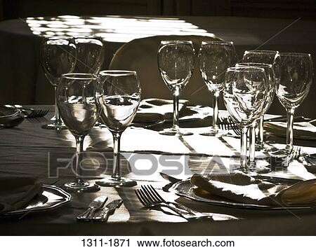 Wine glasses arranged on a table in a restaurant View Large Photo Image Stock Image - Wine glasses arranged on a table in a restaurant. Fotosearch