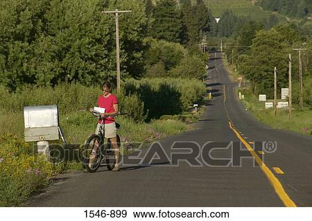 Woman reading a mail by a country mailbox while riding a bicycle, Parkdale, Hood River County, Oregon, USA View Large Photo Image Stock Photo - Woman reading a mail by a country mailbox while riding a bicycle, Parkdale, Hood River County, Oregon, USA. Fotosearch