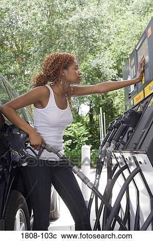 Young woman refueling a car View Large Photo Image Stock Image - Young woman refueling a car. Fotosearch