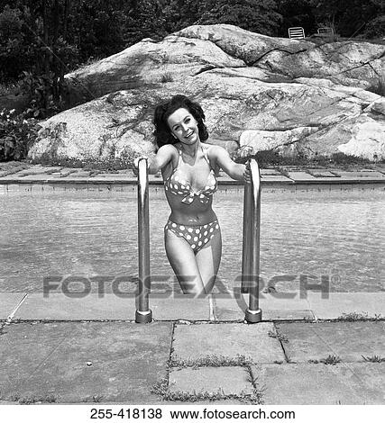 Stock Photo - Beautiful woman in bikini at swimming pool. Fotosearch