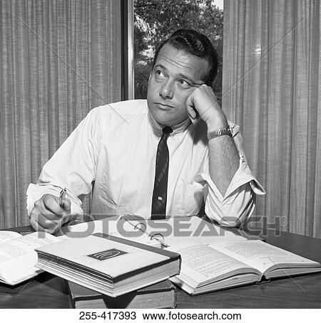 Bored businessman sitting in the office and looking away View Large Photo Image Stock Image - Bored businessman sitting in the office and looking away. Fotosearch