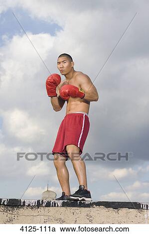 Stock Image - Boxer practicing on a rooftop, New York City, New York State, USA. Fotosearch