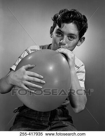 Boy blowing balloon View Large Photo Image Stock Photography - Boy blowing balloon. Fotosearch