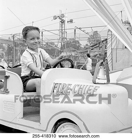Boy in amusement park View Large Photo Image Stock Image - Boy in amusement park. Fotosearch