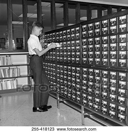 Stock Image - Boy in library. Fotosearch