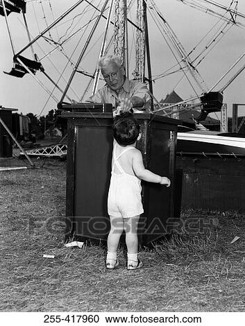 Boy paying for amusement park ride View Large Photo Image Stock Image - Boy paying for amusement park ride. Fotosearch