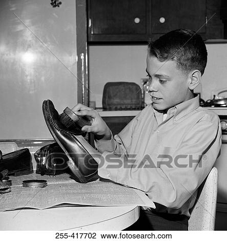 Stock Image - Boy polishing shoes. Fotosearch