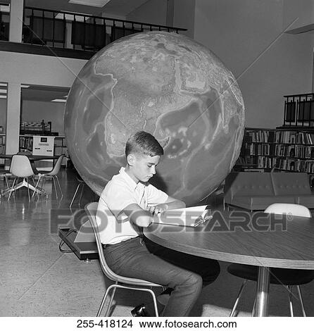 Boy reading book in library View Large Photo Image Picture - Boy reading book in library. Fotosearch