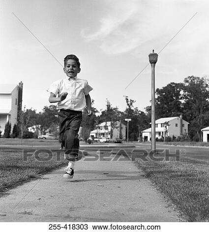 Boy running on pavement View Large Photo Image Stock Image - Boy running on pavement. Fotosearch