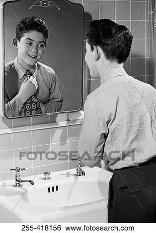 Stock Photograph - Boy tying tie. Fotosearch