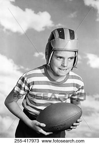 Boy wearing baseball helmet and holding baseball View Large Photo Image Stock Image - Boy wearing baseball helmet and holding baseball. Fotosearch