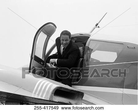 Stock Photo - Businessman boarding private plane. Fotosearch