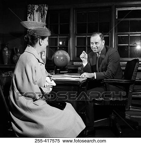 Businessman talking to woman in office View Large Photo Image Stock Photography - Businessman talking to woman in office. Fotosearch