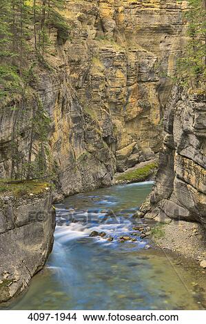 Canyon passing through rock formations, Maligne Canyon, Jasper National Park, Alberta, Canada View Large Photo Image Picture - Canyon passing through rock formations, Maligne Canyon, Jasper National Park, Alberta, Canada. Fotosearch