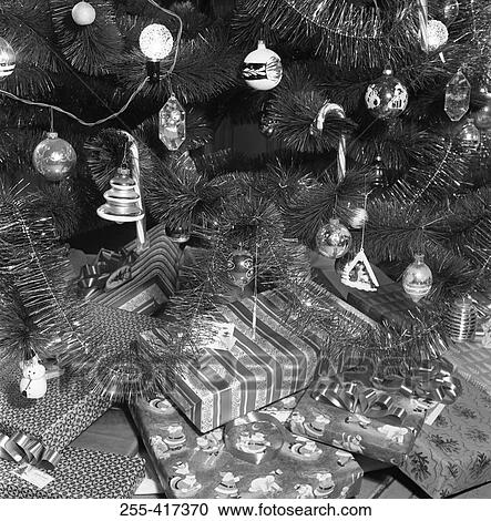 Stock Image - Christmas gifts under Christmas tree, close-up. Fotosearch