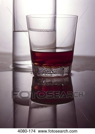 Picture - Close-up of a glass of bourbon with a glass of water. Fotosearch
