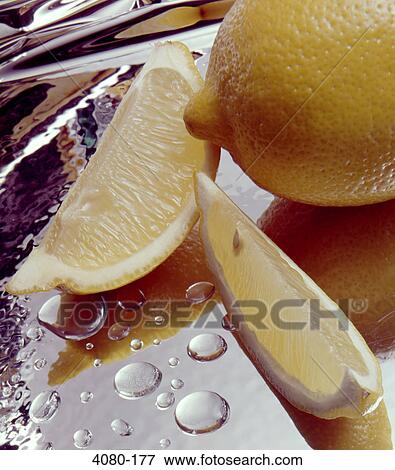 Stock Photo - Close-up of a lemon with lemon slices. Fotosearch