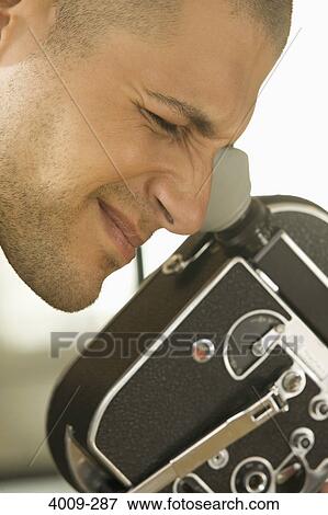 Close-up of a man filming with a video camera, Manhattan, New York City, New York State, USA View Large Photo Image Stock Photo - Close-up of a man filming with a video camera, Manhattan, New York City, New York State, USA. Fotosearch