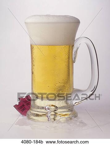 Stock Image - Close-up of a mug of beer with sports tickets. Fotosearch