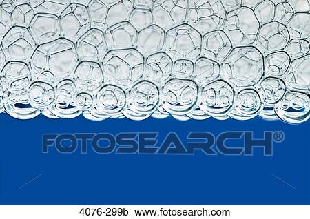 Stock Image - Close-up of soap suds in water. Fotosearch
