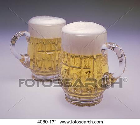 Close-up of two mugs of beer View Large Photo Image Stock Image - Close-up of two mugs of beer. Fotosearch