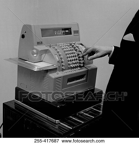 Stock Photo - Close-up view of male cashier working on till. Fotosearch