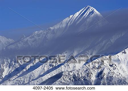 Clouds over snow covered mountains, Kootenay National Park, British Columbia, Canada View Large Photo Image Stock Photography - Clouds over snow covered mountains, Kootenay National Park, British Columbia, Canada. Fotosearch