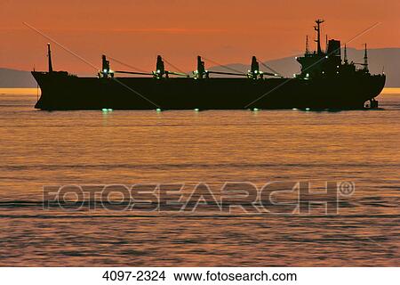 Container ship in the sea at sunset, English Bay, Vancouver, British Columbia, Canada View Large Photo Image Picture - Container ship in the sea at sunset, English Bay, Vancouver, British Columbia, Canada. Fotosearch