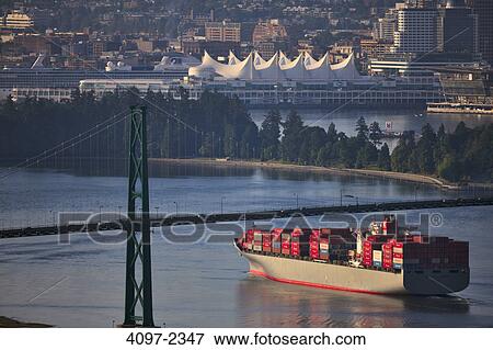Stock Photo - Container ship in the sea at sunset, Burrard Inlet, Vancouver, British Columbia, Canada. Fotosearch