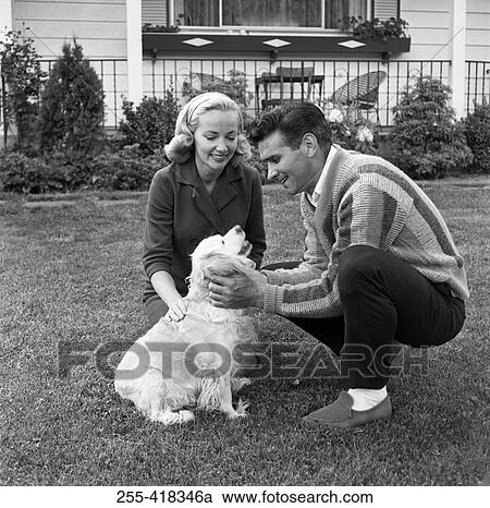 Couple playing with dog View Large Photo Image Stock Image - Couple playing with dog. Fotosearch