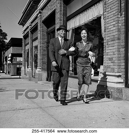 Picture - Couple walking down street. Fotosearch