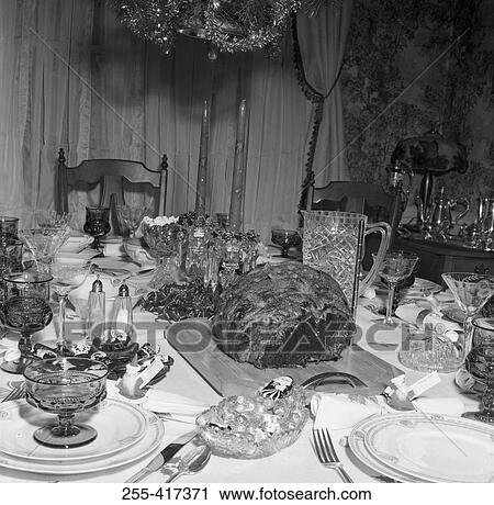 Stock Image - Decorated table with sets and meat waiting for guests. Fotosearch