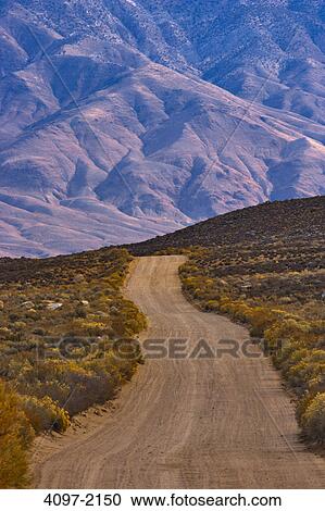 Stock Image - Dirt road passing through a landscape, Buttermilk Road, Californian Sierra Nevada, California, USA. Fotosearch