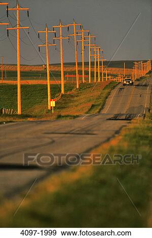 Stock Photo - Electricity pylons along a highway, Alberta, Canada. Fotosearch