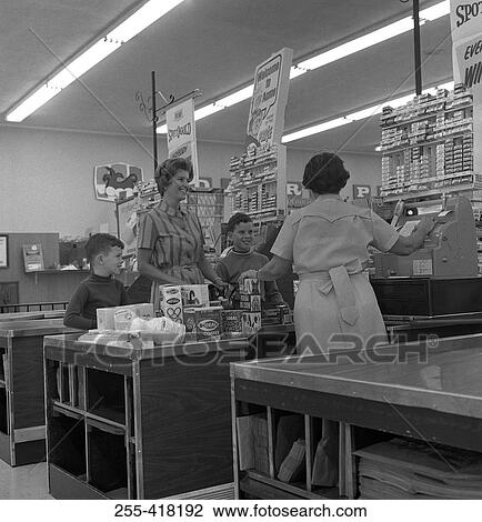 Stock Image - Family shopping in supermarket. Fotosearch