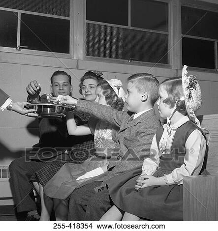 Picture - Family sitting in church. Fotosearch
