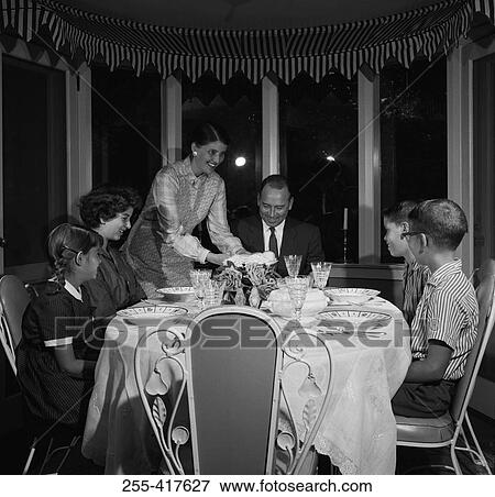 Family with children at dining room table View Large Photo Image Stock Photo - Family with children at dining room table. Fotosearch