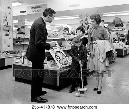 Stock Photo - Family with two children in toy shop. Fotosearch