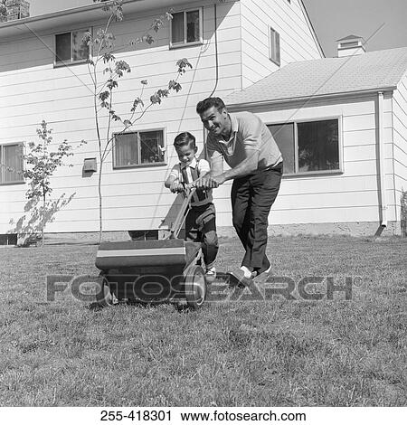 Father and son with lawn mower View Large Photo Image Stock Image - Father and son with lawn mower. Fotosearch