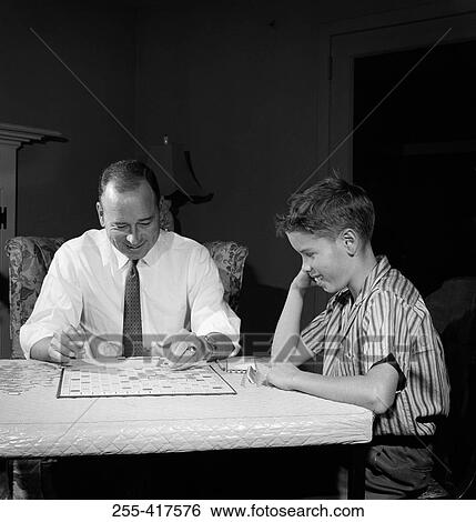Father playing scrabble with son in home View Large Photo Image Stock Photograph - Father playing scrabble with son in home. Fotosearch