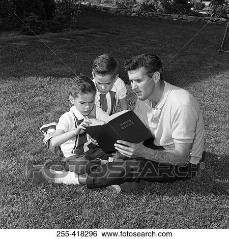 Father with twin sons reading book sitting on lawn View Large Photo Image Stock Photograph - Father with twin sons reading book sitting on lawn. Fotosearch