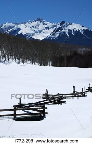 Fence in a snow covered landscape, Rocky Mountains, USA View Large Photo Image Stock Photo - Fence in a snow covered landscape, Rocky Mountains, USA. Fotosearch